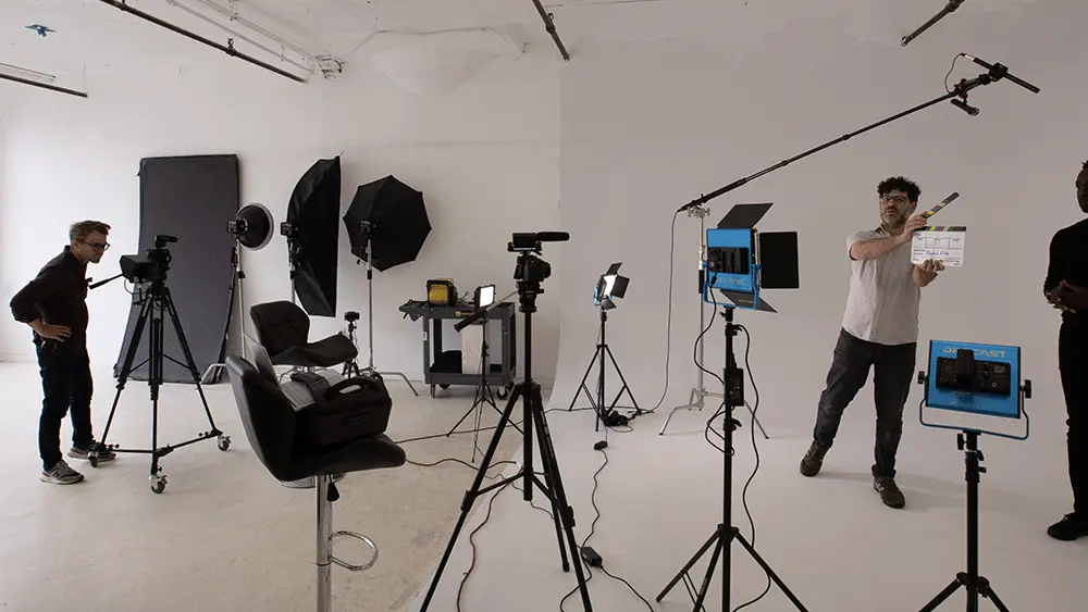 Flywheel Film production team preparing cameras, lighting and sound for an interview